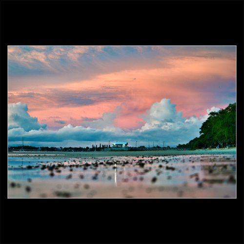 Sunset over Bongaree Beach with dramatic clouds and reflective shoreline, Bribie Island.