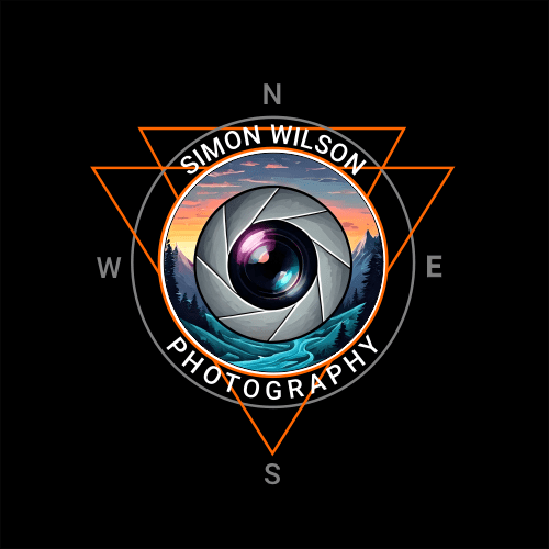 Simon Wilson Photography logo featuring a camera lens with a scenic landscape of mountains, trees, and a river at sunset, encircled by a compass and orange geometric triangles.